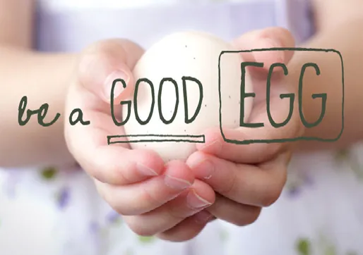 Be a Good Egg in-store campaign message written across four knuckles