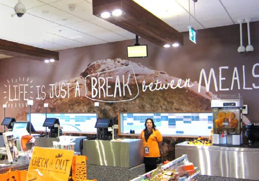 The Herdsman Perth checkout counter with orange signage and a hand-lettered wall message