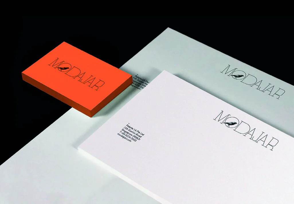 Modajar business cards, letterhead and envelopes with a vivid orange accent