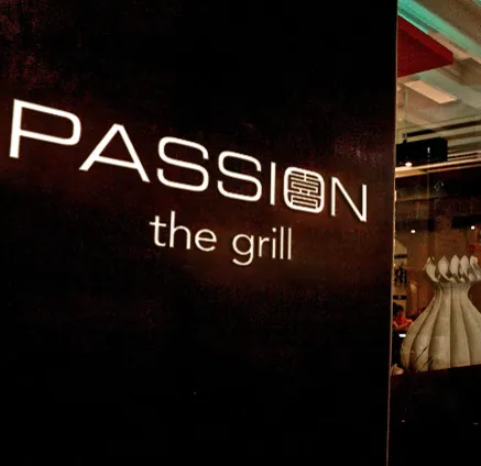 Illuminated Passion the Grill restaurant sign using the group identity system